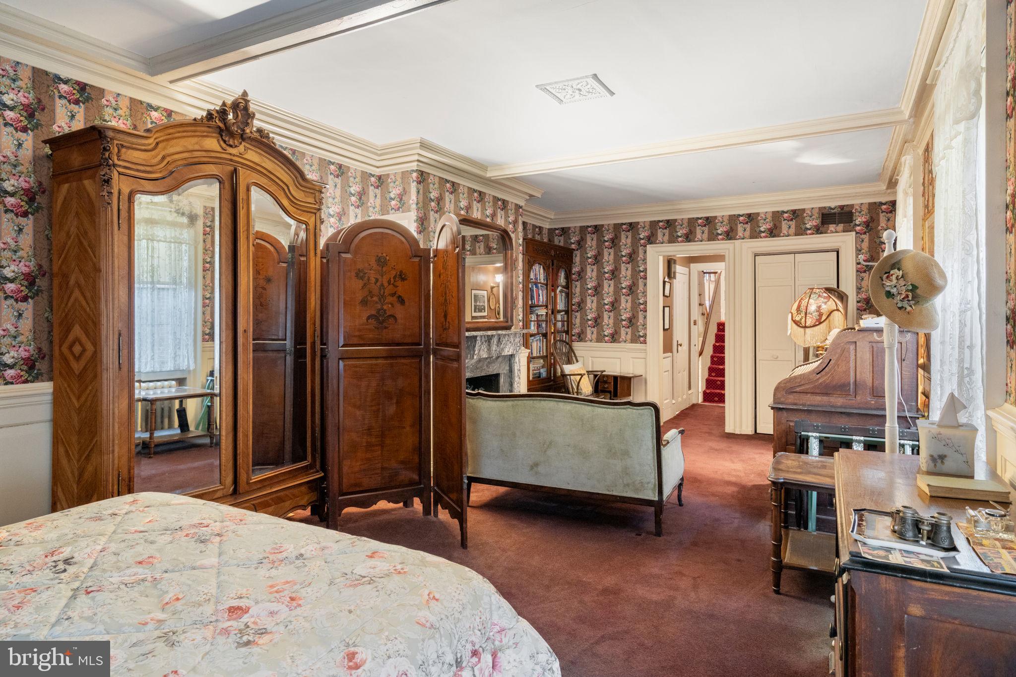 1017 Clinton Street Philadelphia, PA 19107 - Photo 24 of 38 a bedroom with a bed and a mirror