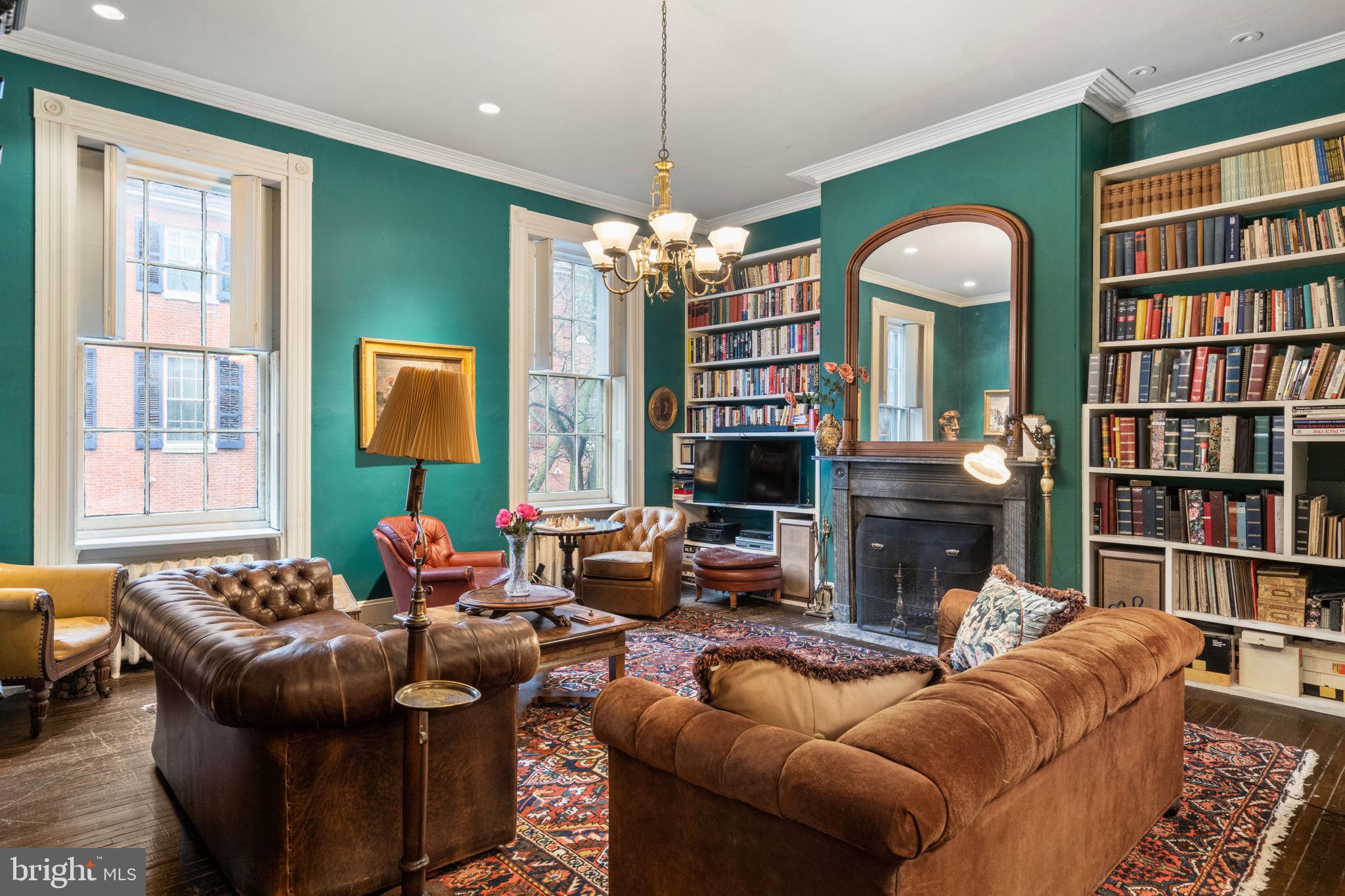 1017 Clinton Street Philadelphia, PA 19107 - Photo 28 of 38 a living room with fireplace furniture and a book shelf