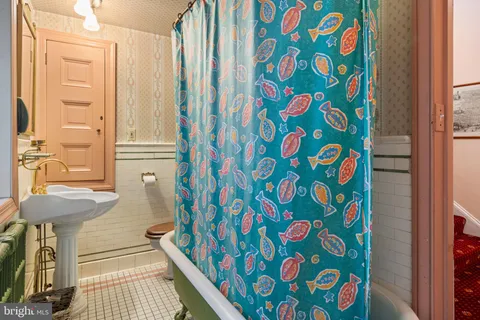 a bathroom with a sink and a shower curtain