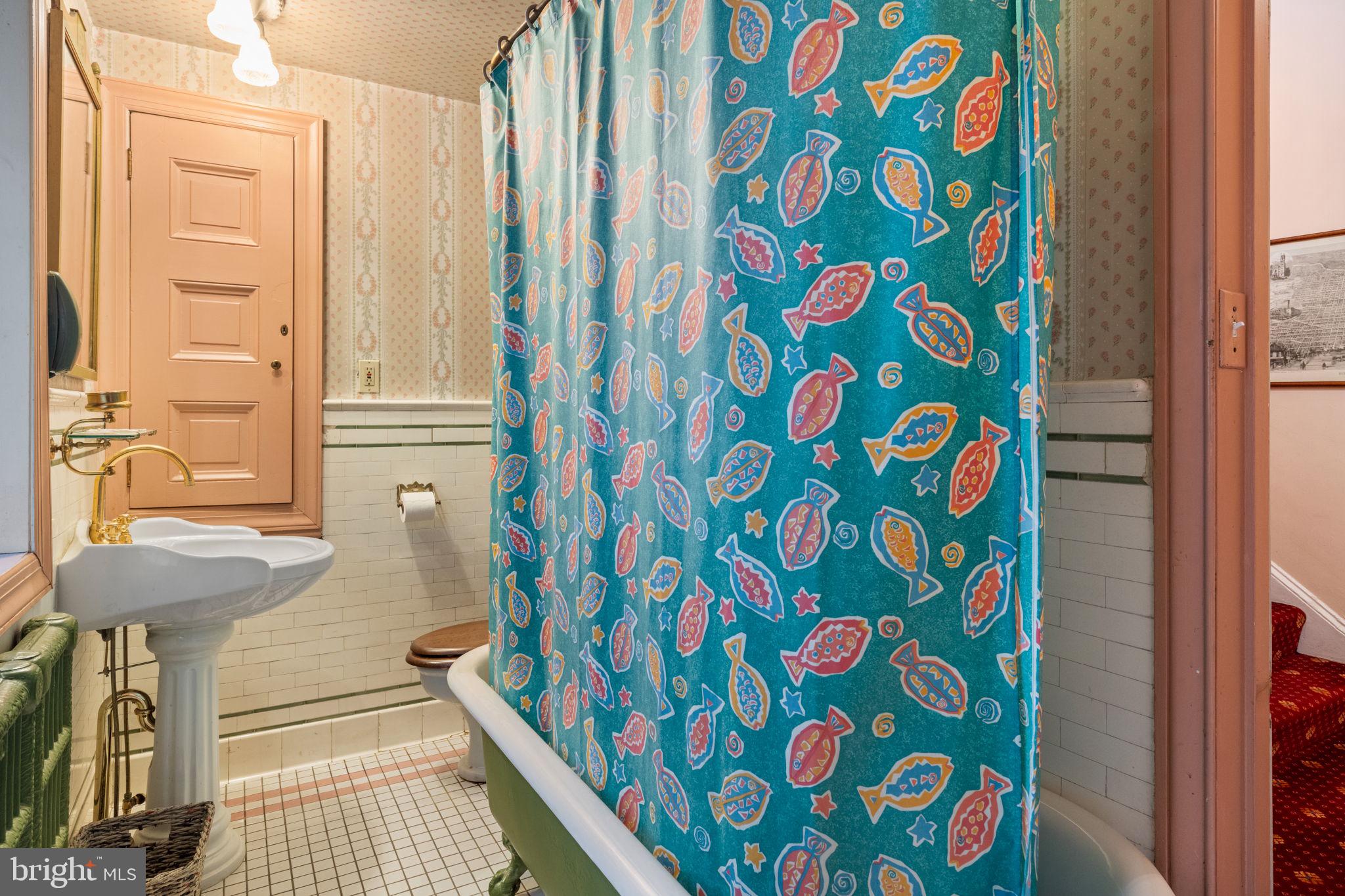 1017 Clinton Street Philadelphia, PA 19107 - Photo 31 of 38 a bathroom with a sink and a shower curtain