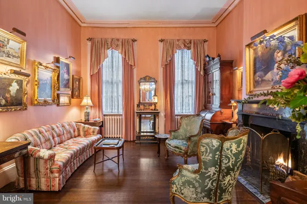 a living room with furniture a fireplace and decor