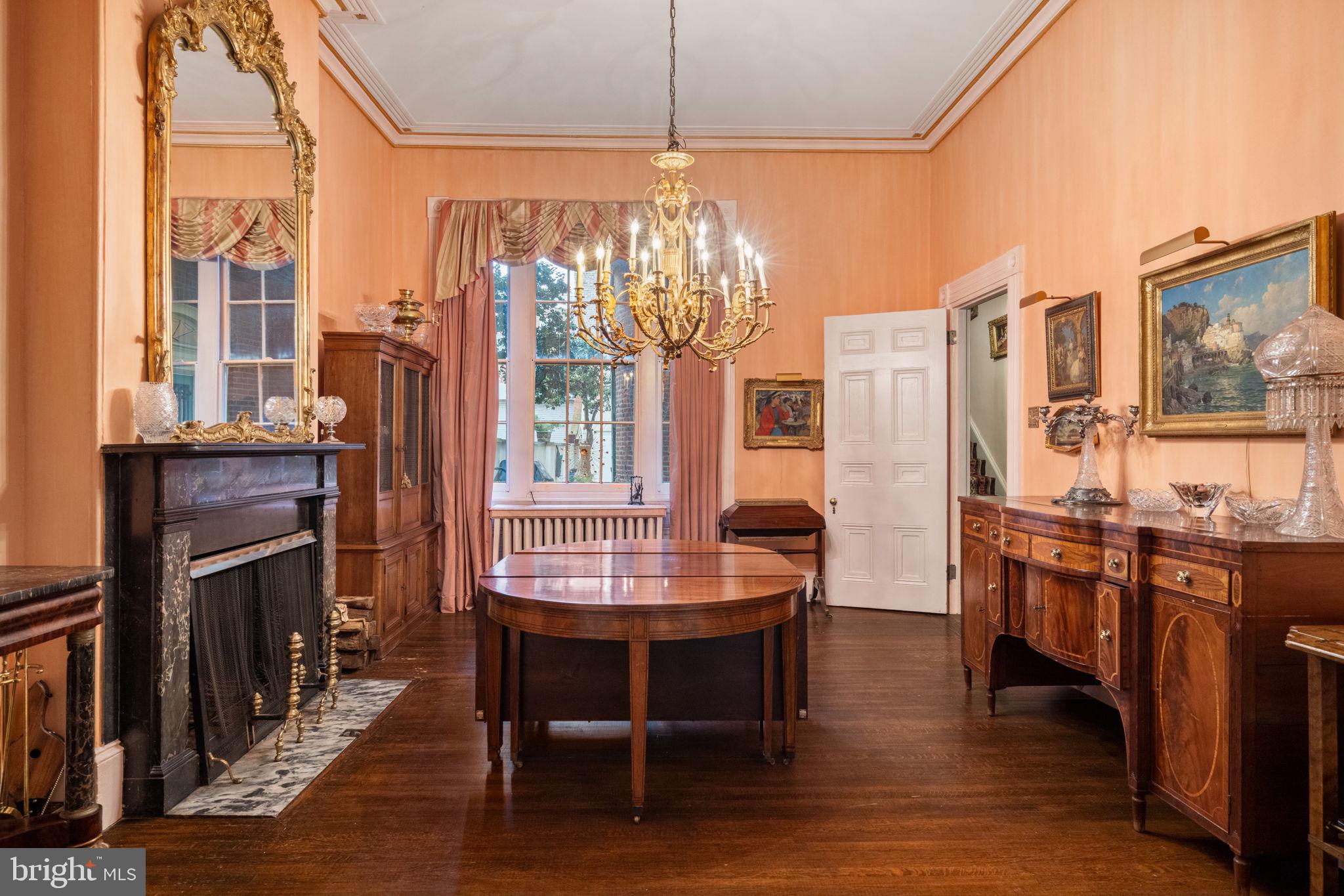 1017 Clinton Street Philadelphia, PA 19107 - Photo 8 of 38 a dining room with furniture a chandelier and wooden floor