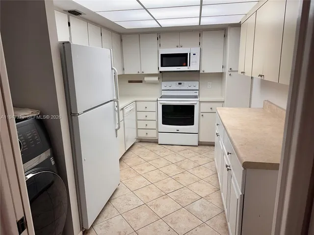 a kitchen with stainless steel appliances a refrigerator stove microwave and sink