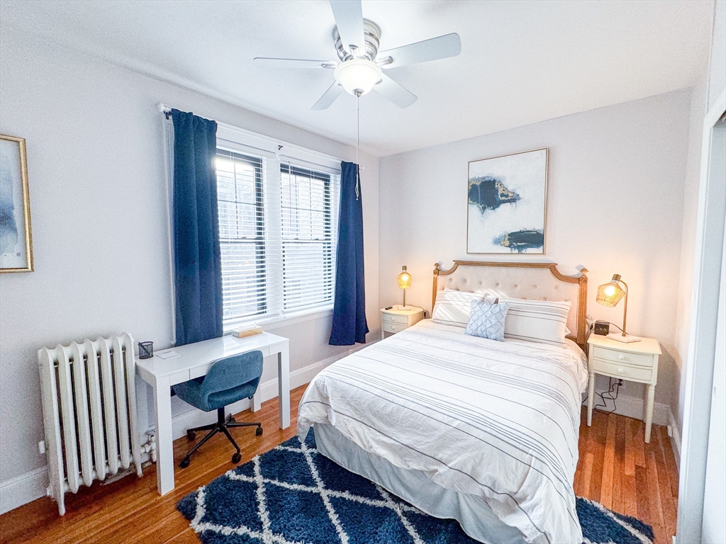 29 Mt Hood Road, Unit 12FURNISHED Boston, MA 02135 - Photo 6 of 11 a bedroom with a bed and a chandelier