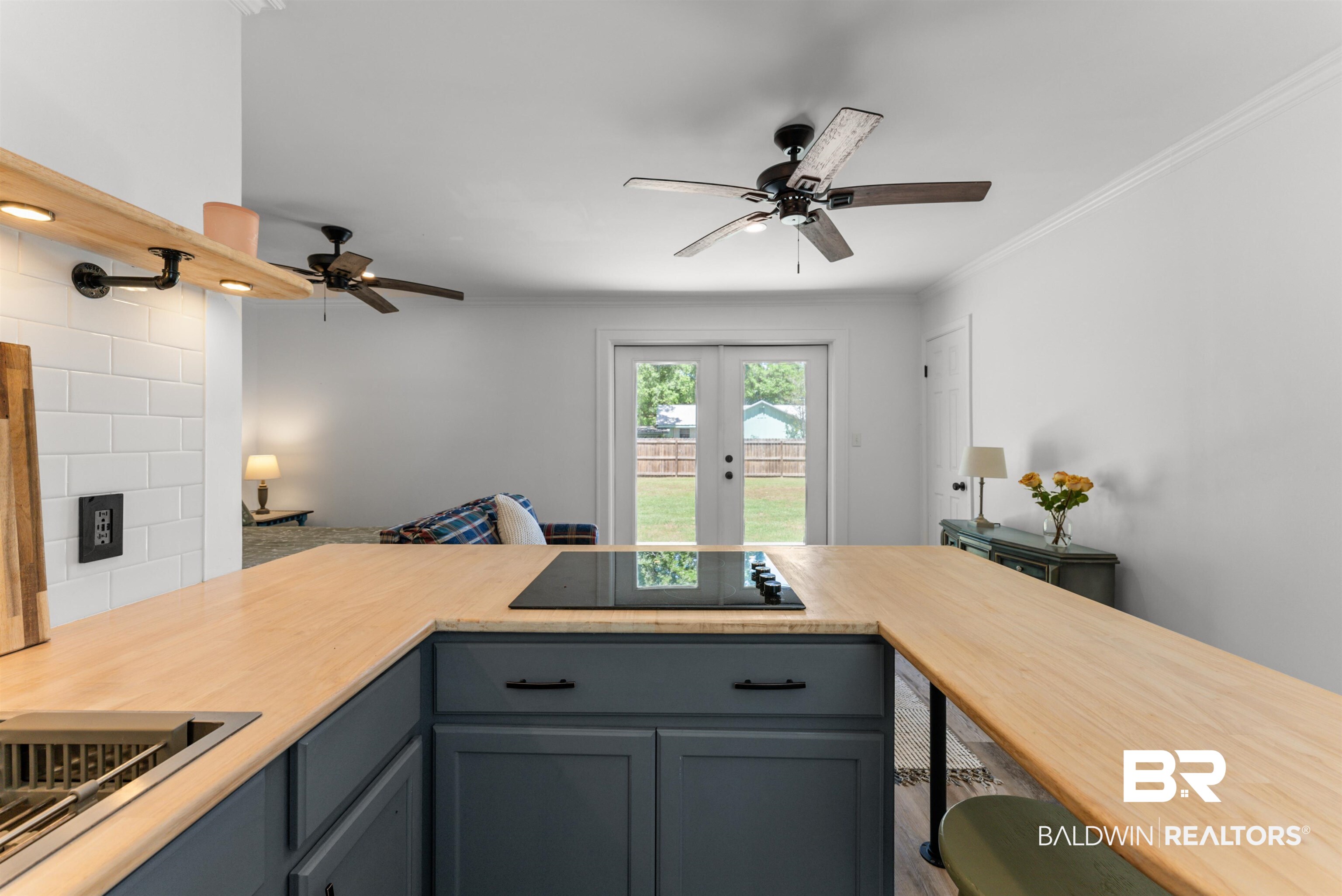 6447 Bemis Lane Bon Secour, AL 36511 - Photo 29 of 62 Modern kitchen island with wood-finish countertop and integrated cooktop
