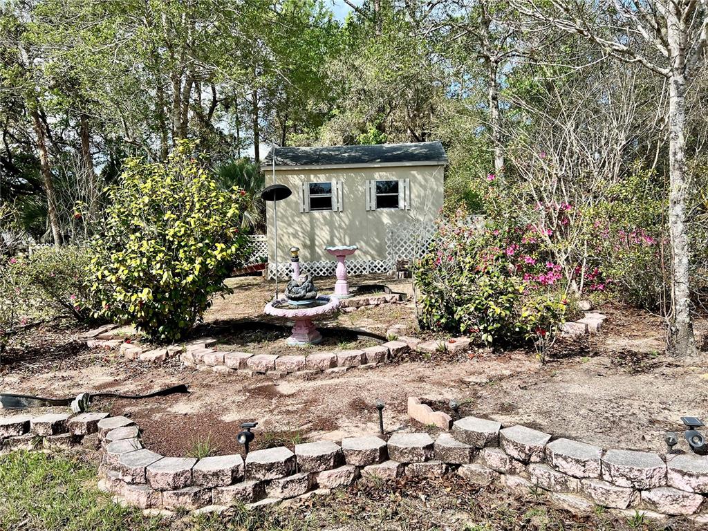 1995 East Newhaven Street Inverness, FL 34453 - Photo 39 of 48 a view of a backyard with sitting area
