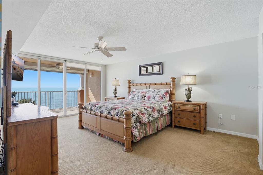 16326 Gulf Boulevard, Unit 307 Redington Beach, FL 33708 - Photo 13 of 43 a bedroom with a bed and a chandelier