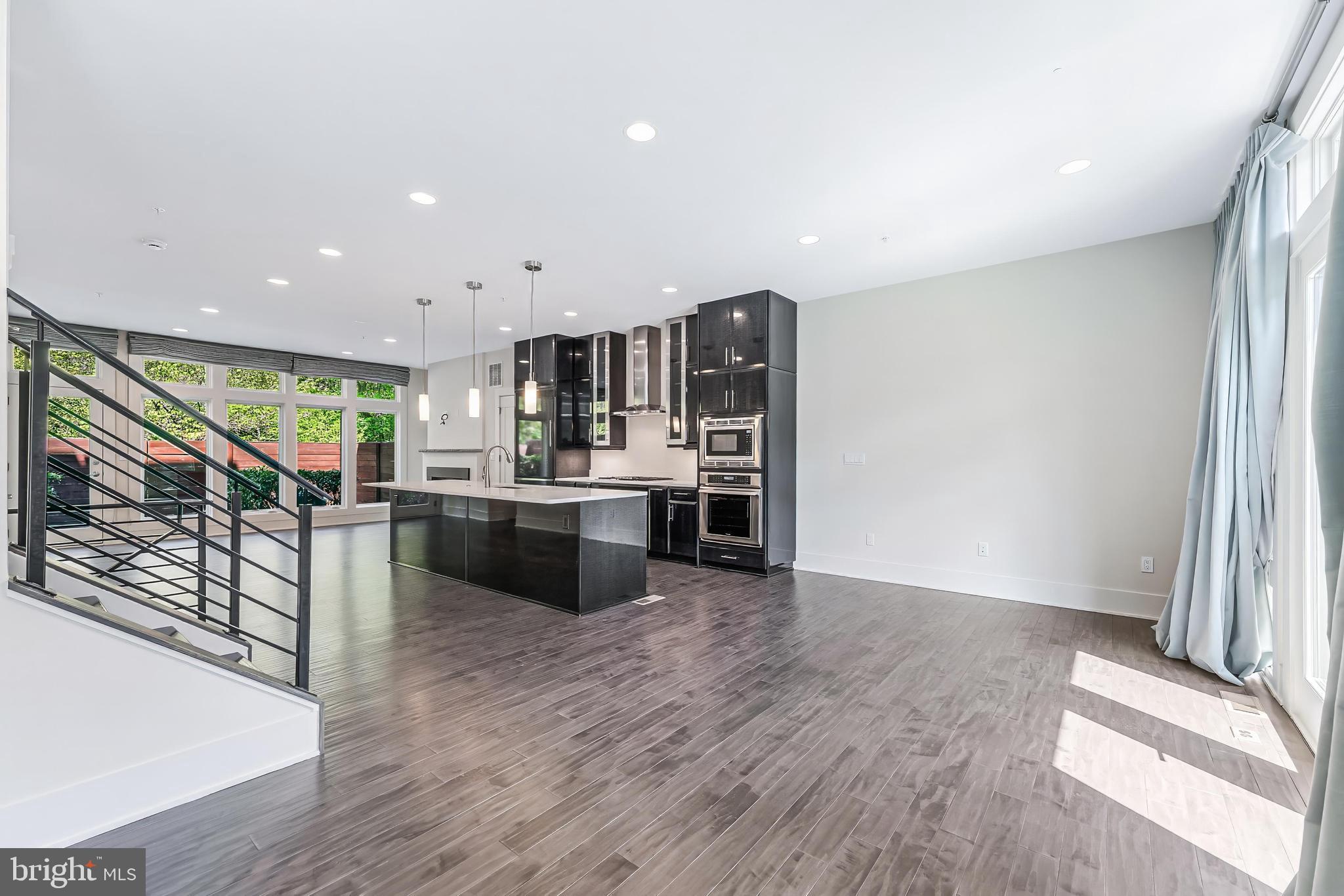 5125 Willet Bridge Road Bethesda, MD 20816 - Photo 14 of 47 a view of kitchen with kitchen island stainless steel appliances wooden floor and window