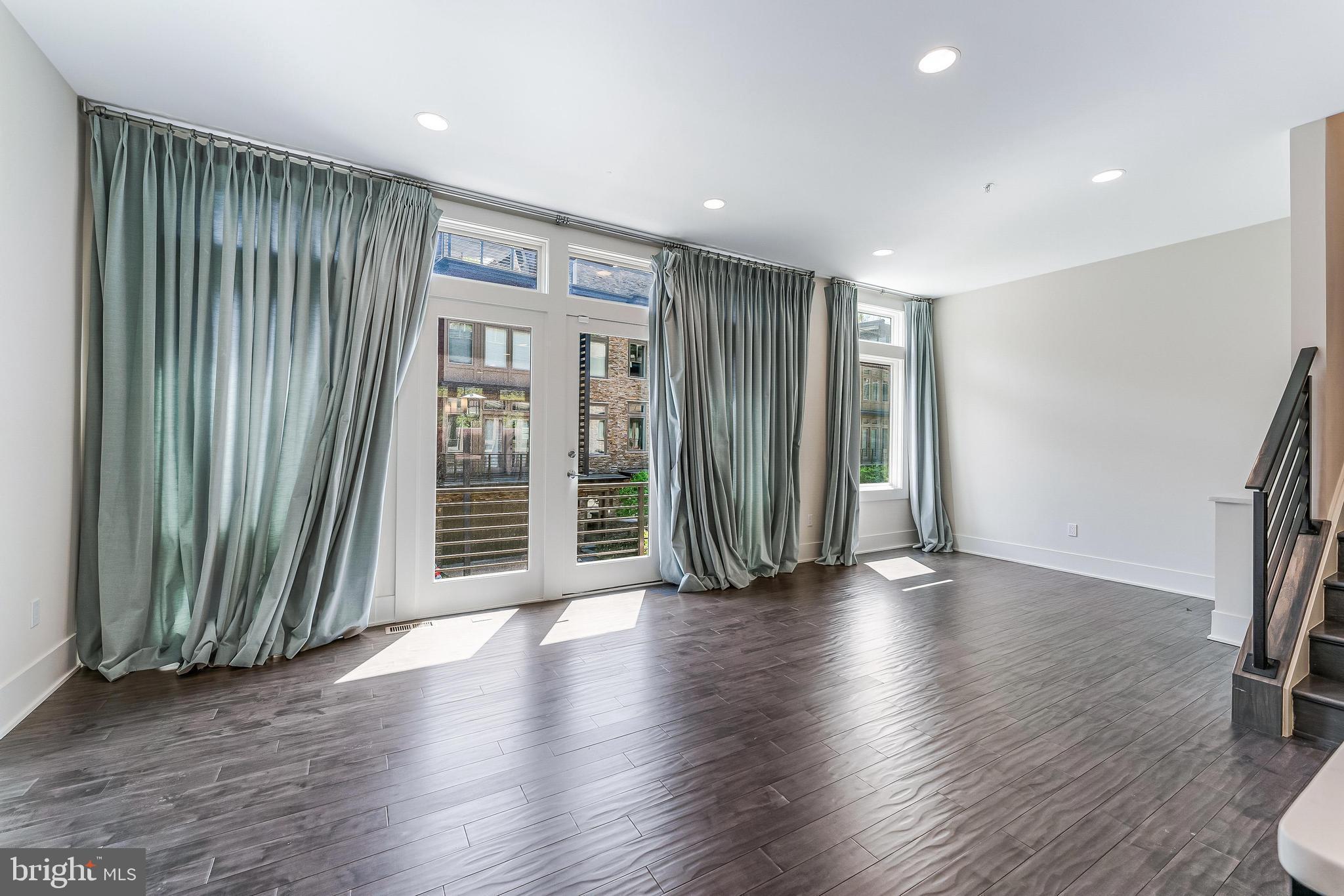 5125 Willet Bridge Road Bethesda, MD 20816 - Photo 15 of 47 an empty room with wooden floor and windows