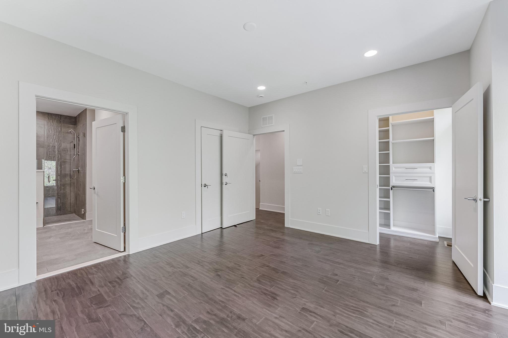 5125 Willet Bridge Road Bethesda, MD 20816 - Photo 20 of 47 wooden floor in an empty room with wooden door