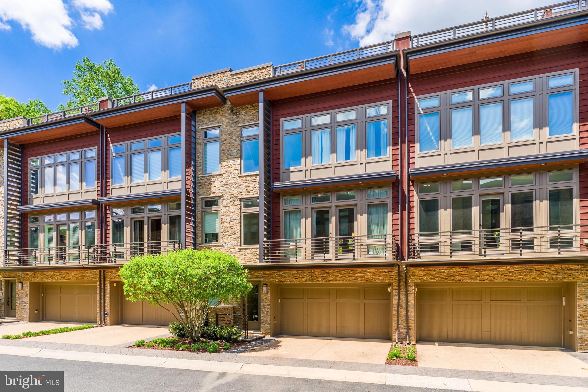 5125 Willet Bridge Road Bethesda, MD 20816 - Photo 2 of 47 a front view of a building with a garden and balcony