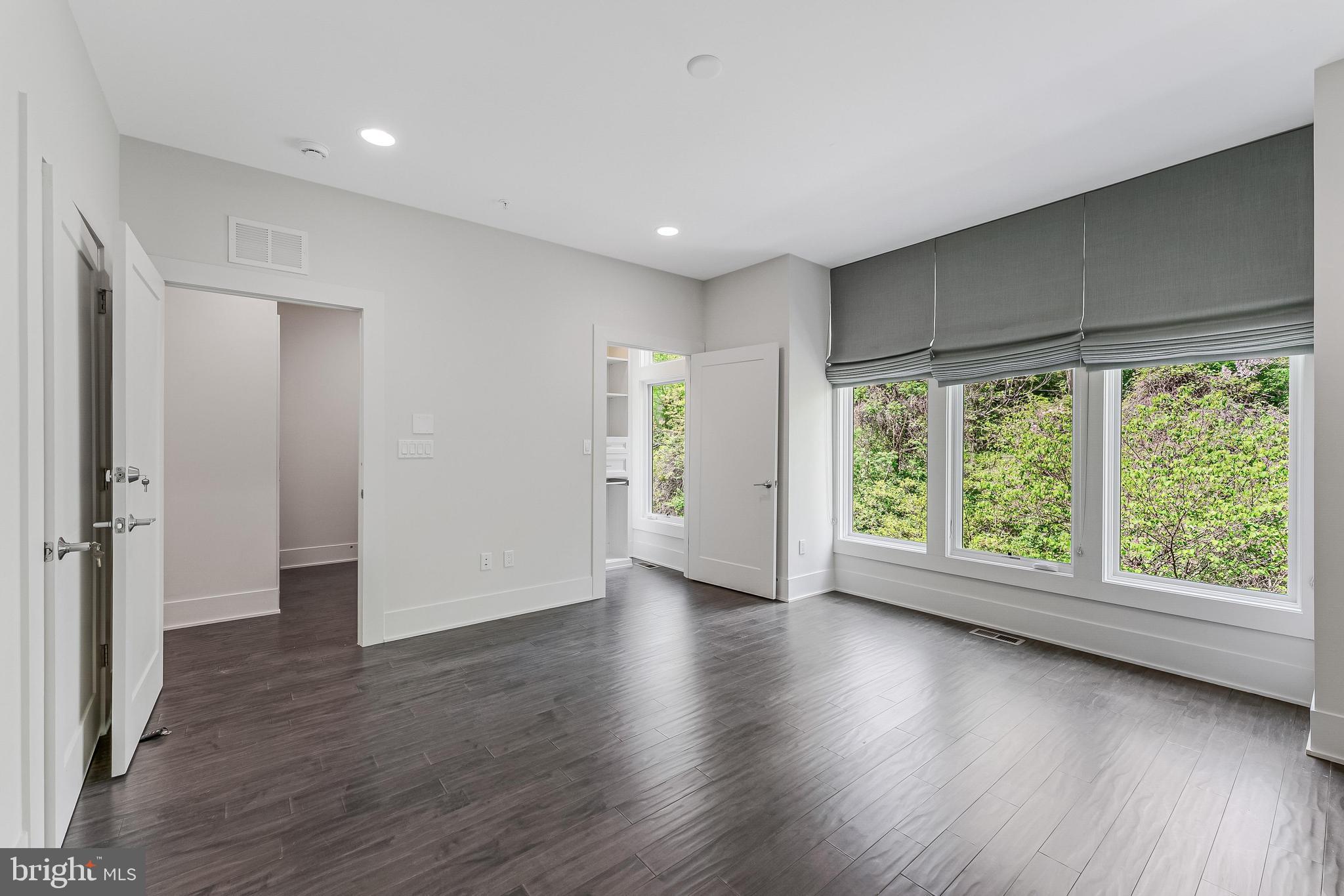 5125 Willet Bridge Road Bethesda, MD 20816 - Photo 21 of 47 a view of an empty room with wooden floor and a window