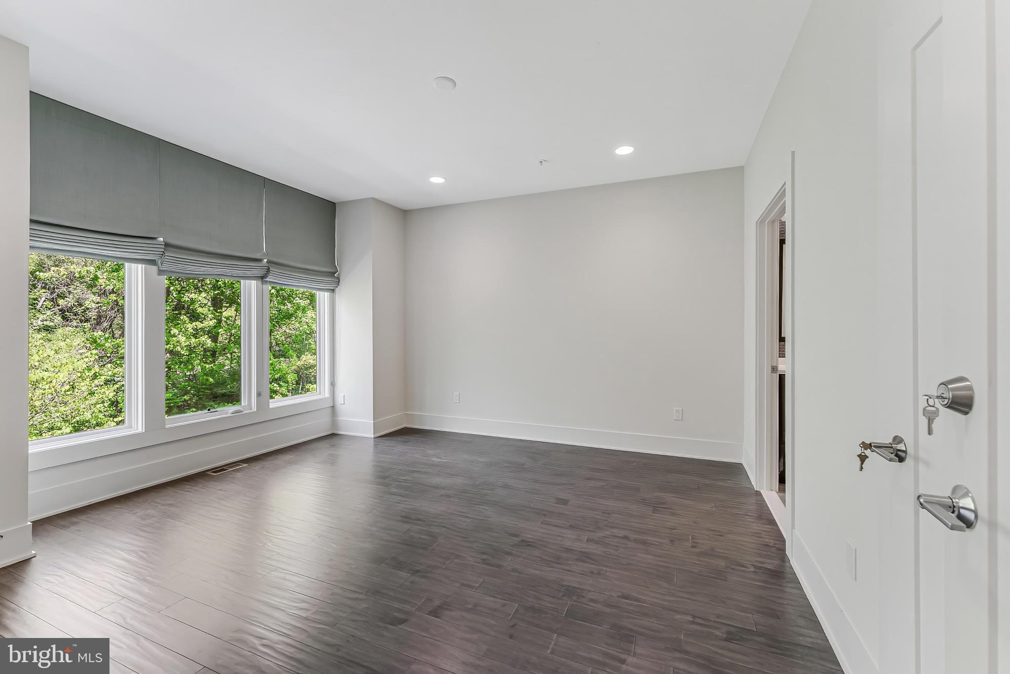 5125 Willet Bridge Road Bethesda, MD 20816 - Photo 22 of 47 a view of a livingroom with wooden floor and a window