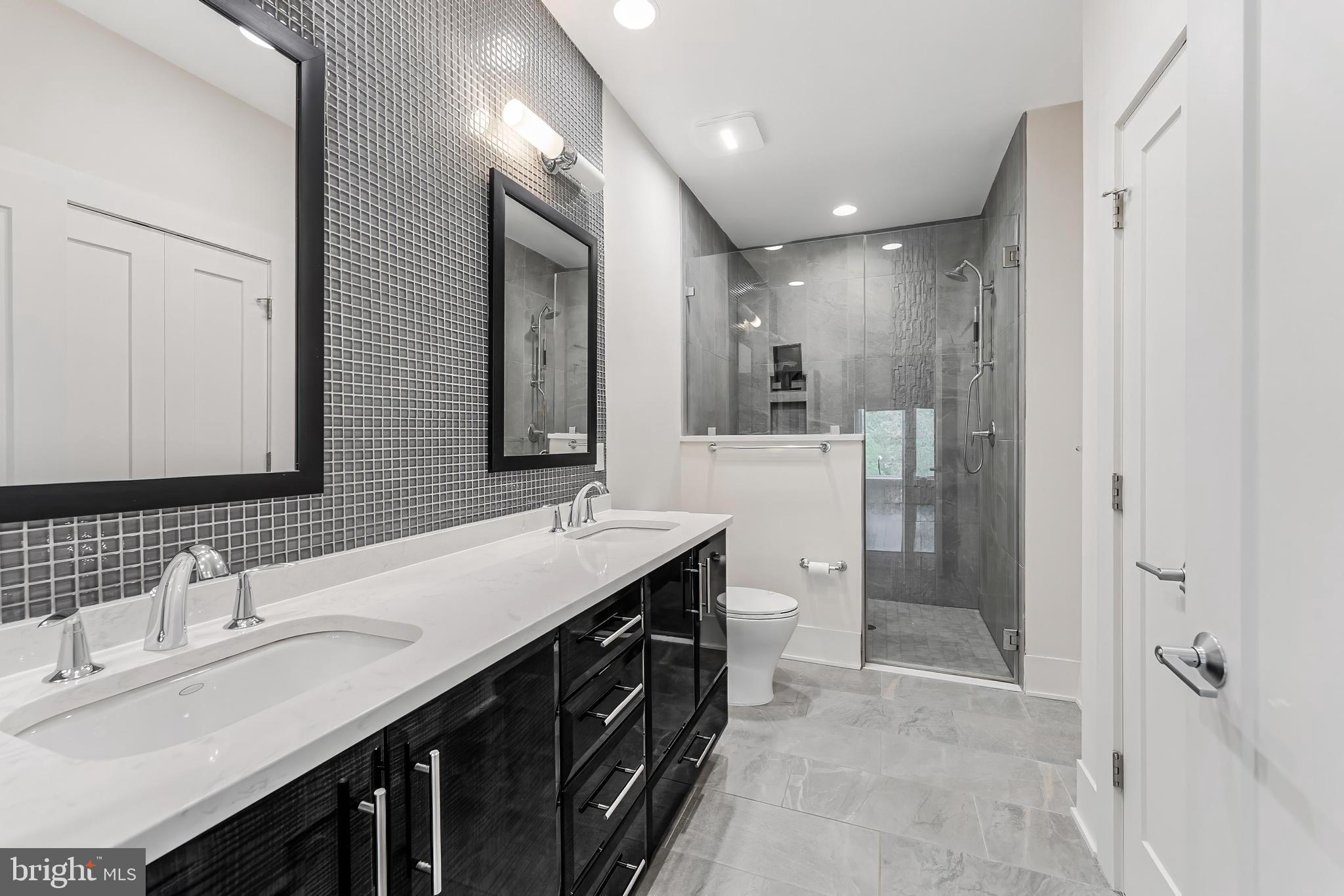 5125 Willet Bridge Road Bethesda, MD 20816 - Photo 23 of 47 a spacious bathroom with a double vanity sink mirror double and shower