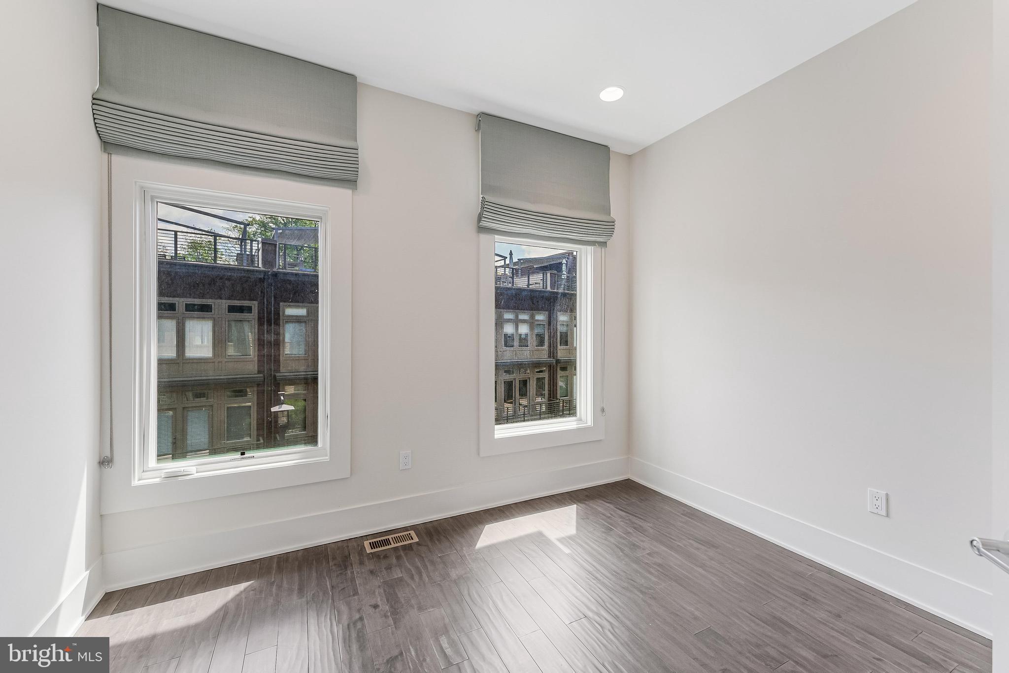 5125 Willet Bridge Road Bethesda, MD 20816 - Photo 26 of 47 a view of an empty room with wooden floor and a window