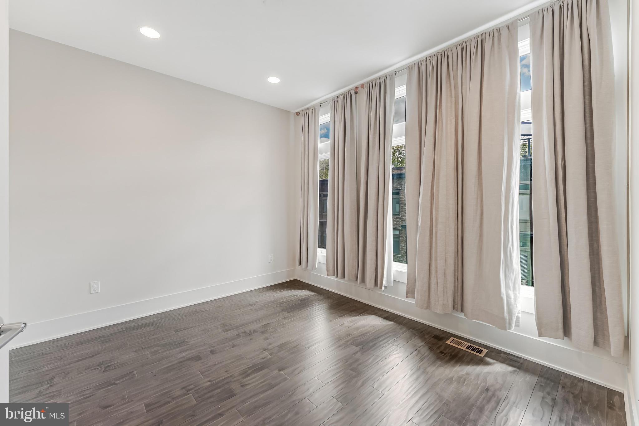 5125 Willet Bridge Road Bethesda, MD 20816 - Photo 27 of 47 a view of an empty room with wooden floor