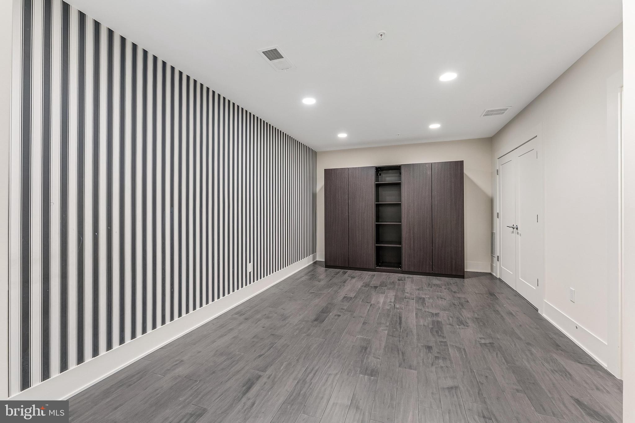 5125 Willet Bridge Road Bethesda, MD 20816 - Photo 43 of 47 a view of an empty room with wooden floor