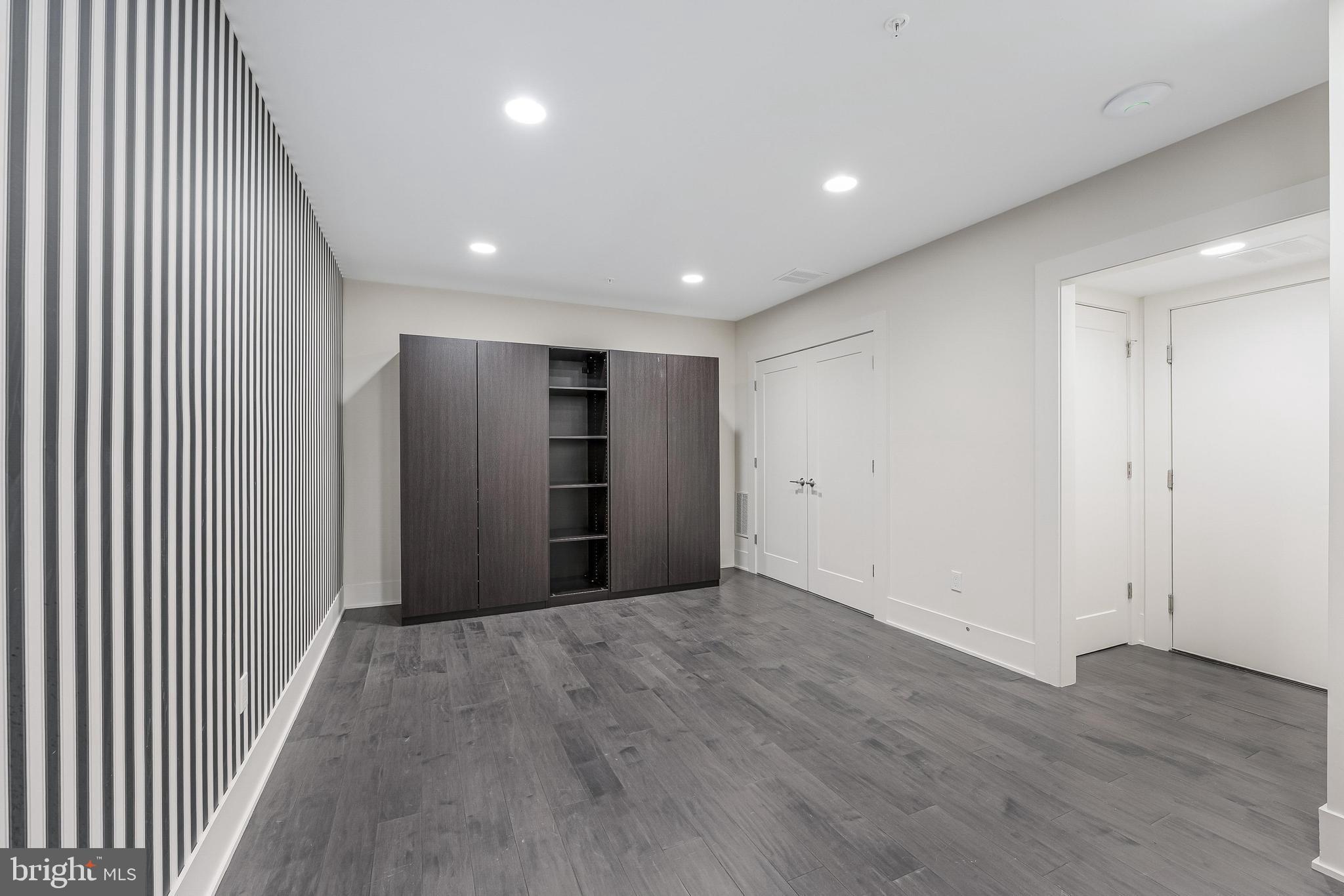 5125 Willet Bridge Road Bethesda, MD 20816 - Photo 44 of 47 an empty room with wooden floor