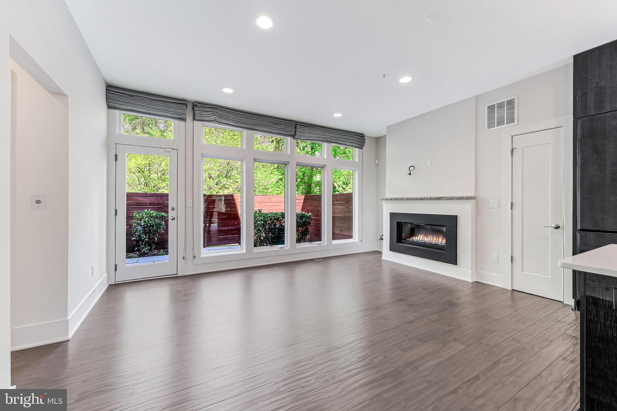 5125 Willet Bridge Road Bethesda, MD 20816 - Photo 8 of 47 a view of an empty room with wooden floor and a window
