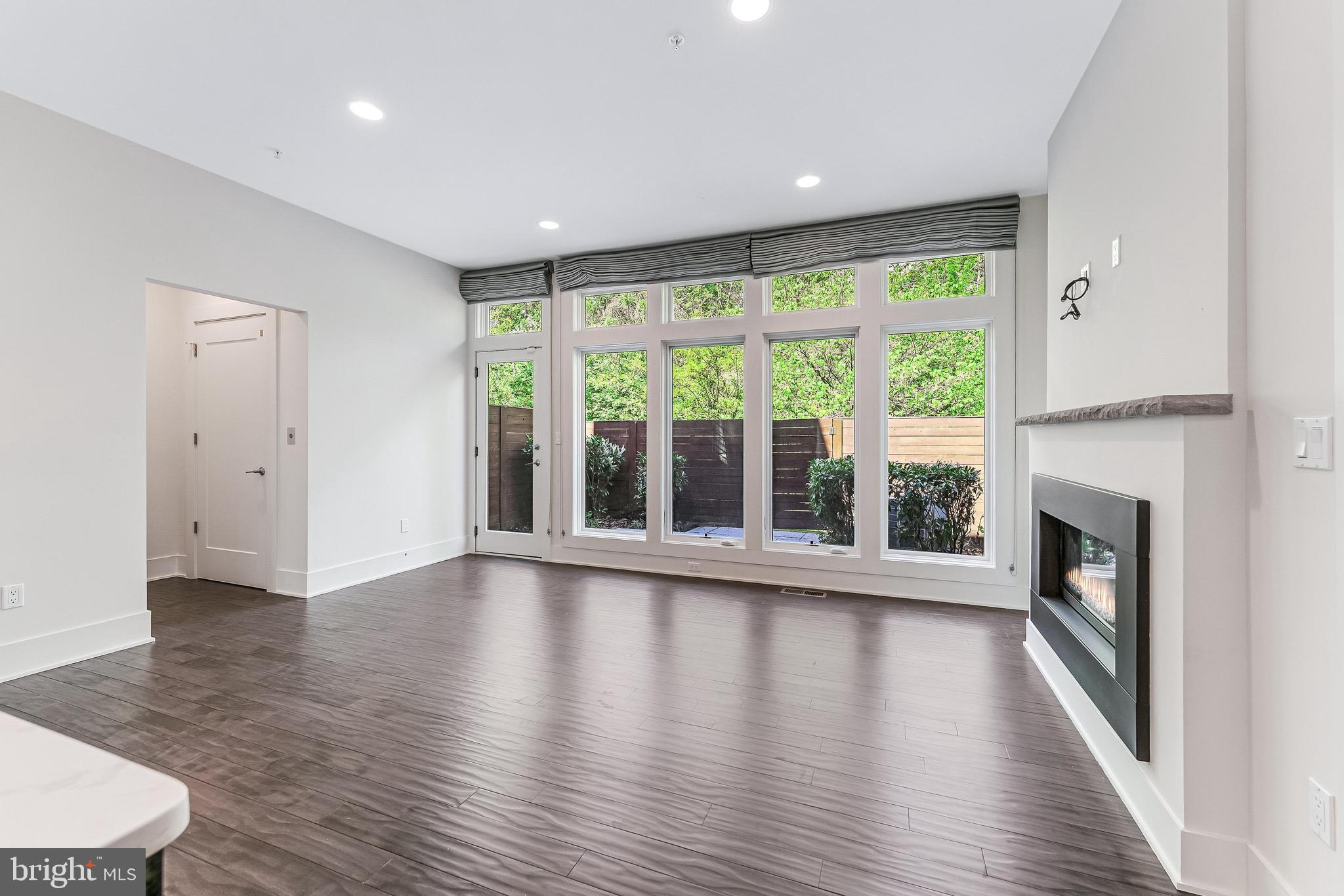 5125 Willet Bridge Road Bethesda, MD 20816 - Photo 9 of 47 a view of an empty room with wooden floor and a window