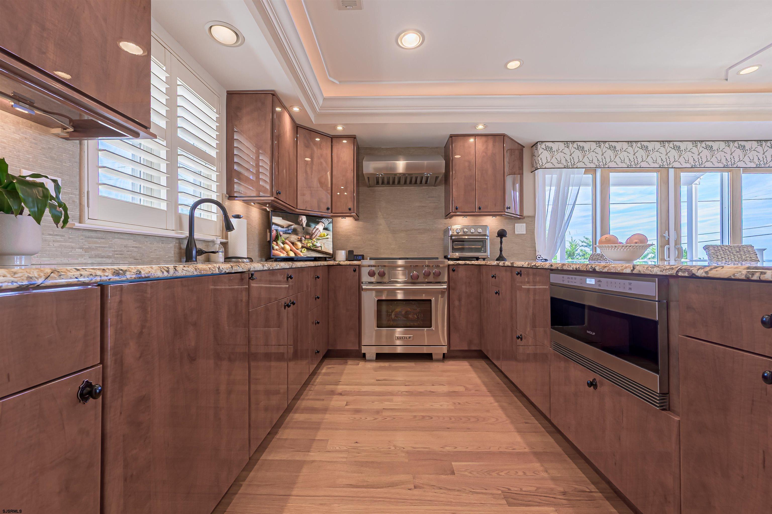 815 East Brigantine Avenue, Unit 7 Brigantine, NJ 08203 - Photo 9 of 31 a kitchen with stainless steel appliances granite countertop a sink and a stove