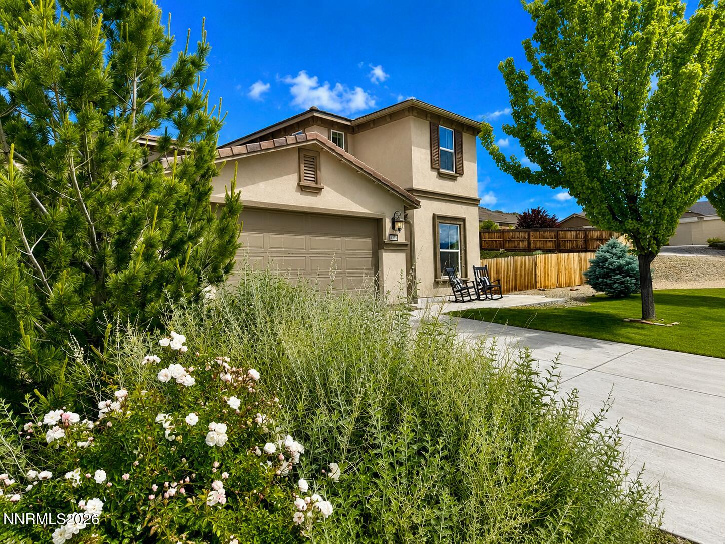 10150 Barrel Racer Drive Reno, NV 89521 - Photo 1 of 64 a view of a house with a small yard plants and a large tree