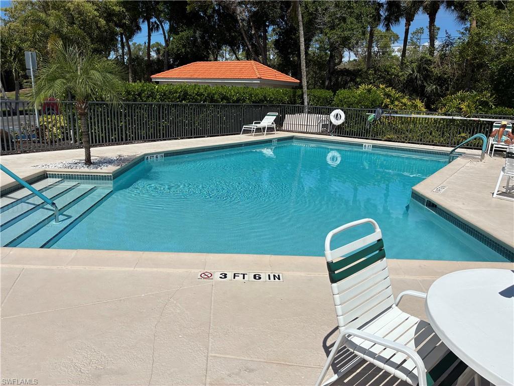 2585 Old Groves Road, Unit L102 Naples, FL 34109 - Photo 17 of 29 a view of a swimming pool with a patio
