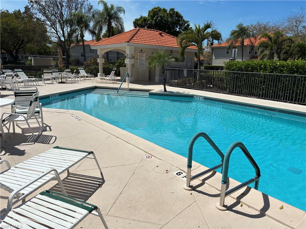 2585 Old Groves Road, Unit L102 Naples, FL 34109 - Photo 18 of 29 a view of swimming pool with outdoor seating and yard