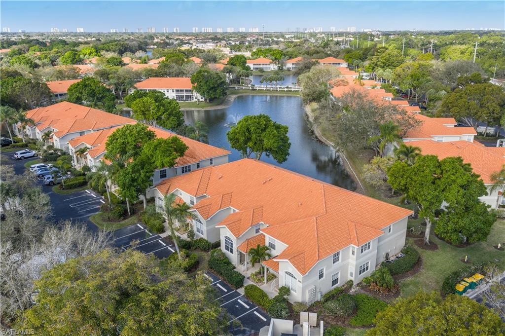 2585 Old Groves Road, Unit L102 Naples, FL 34109 - Photo 20 of 29 an aerial view of a house with a yard and lake view
