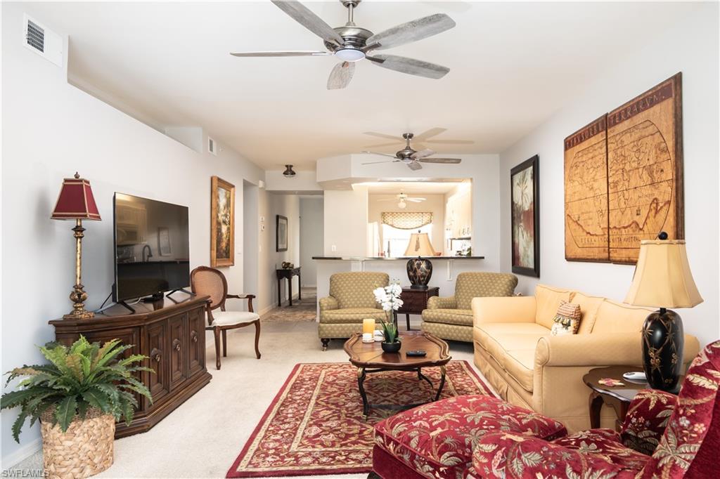 2585 Old Groves Road, Unit L102 Naples, FL 34109 - Photo 2 of 29 a living room with furniture and a flat screen tv