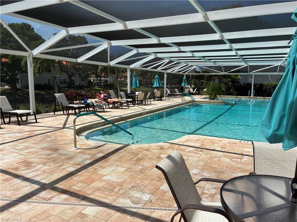 2585 Old Groves Road, Unit L102 Naples, FL 34109 - Photo 25 of 29 a view of a swimming pool with a patio