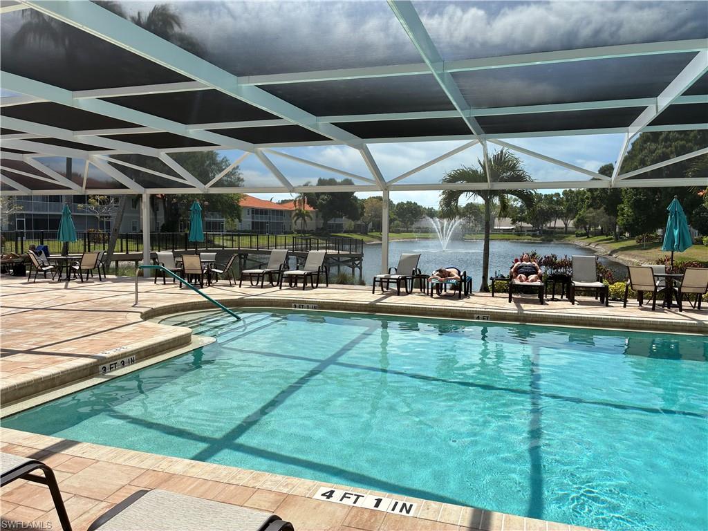 2585 Old Groves Road, Unit L102 Naples, FL 34109 - Photo 26 of 29 a view of a swimming pool with outdoor seating
