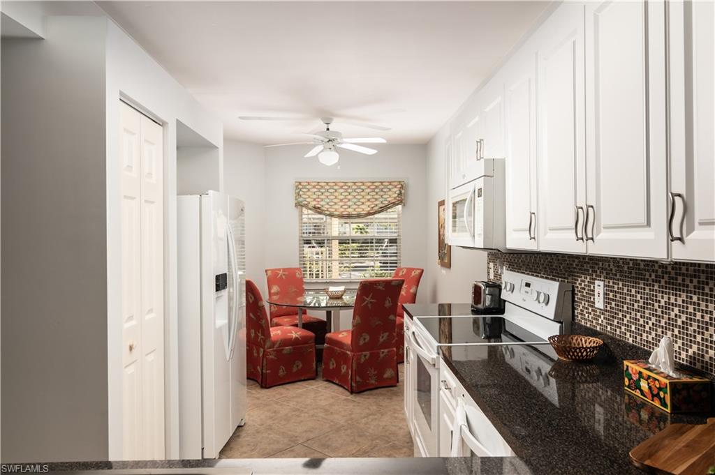 2585 Old Groves Road, Unit L102 Naples, FL 34109 - Photo 5 of 29 a view of a dining room with furniture window and outside view