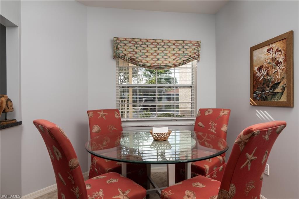 2585 Old Groves Road, Unit L102 Naples, FL 34109 - Photo 6 of 29 a view of a dining room with furniture