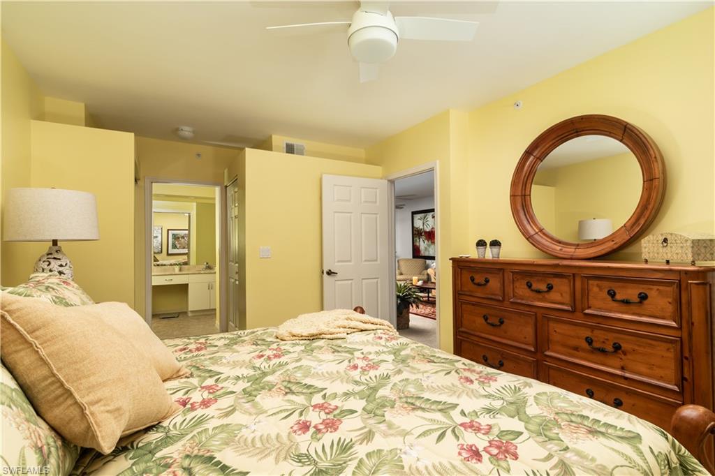 2585 Old Groves Road, Unit L102 Naples, FL 34109 - Photo 9 of 29 a bedroom with a bed and a dresser