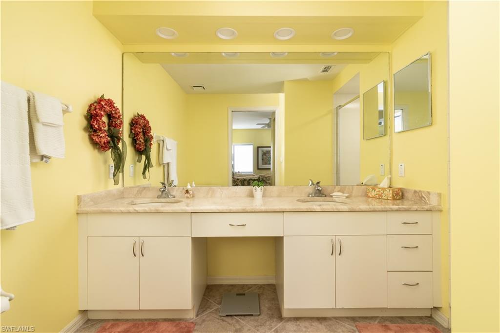 2585 Old Groves Road, Unit L102 Naples, FL 34109 - Photo 10 of 29 a bathroom with a sink and a mirror