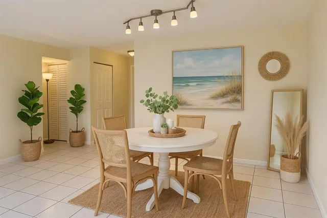 a view of a dining room with furniture and a potted plant