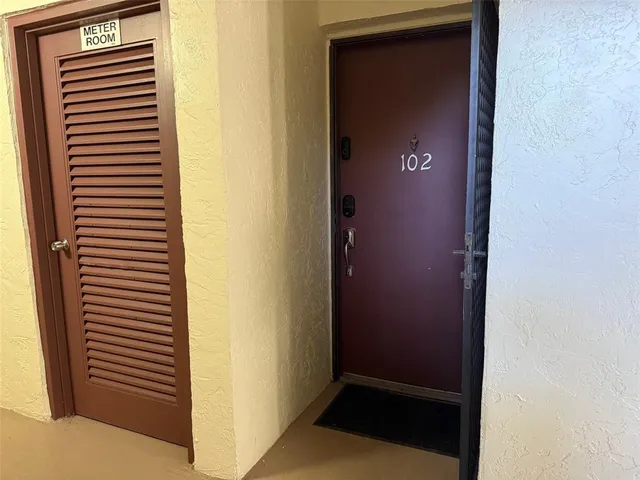 a view of hallway with a bathroom