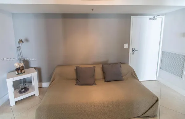 a bedroom with a bed and a fireplace