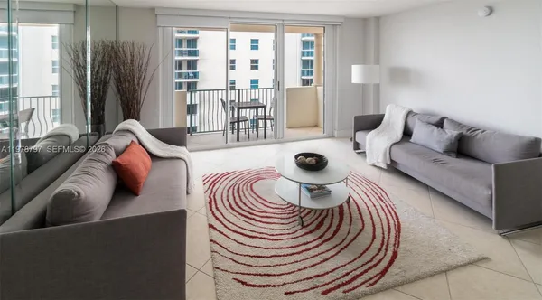 a living room with furniture and a large window