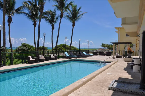 a view of a swimming pool with a table and chairs