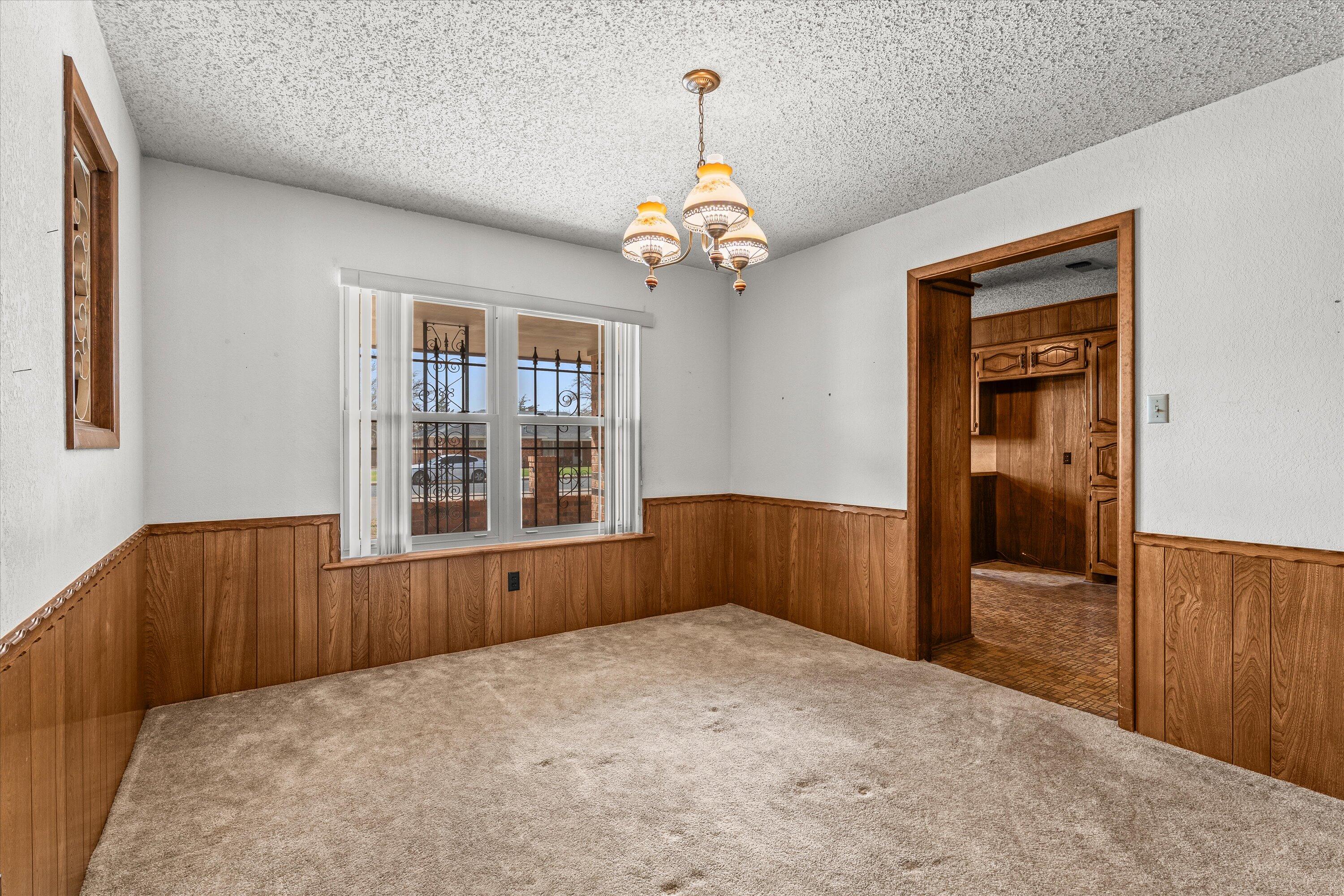 308 West 6th Street Sundown, TX 79372 - Photo 12 of 33 wooden floor in an empty room with a window