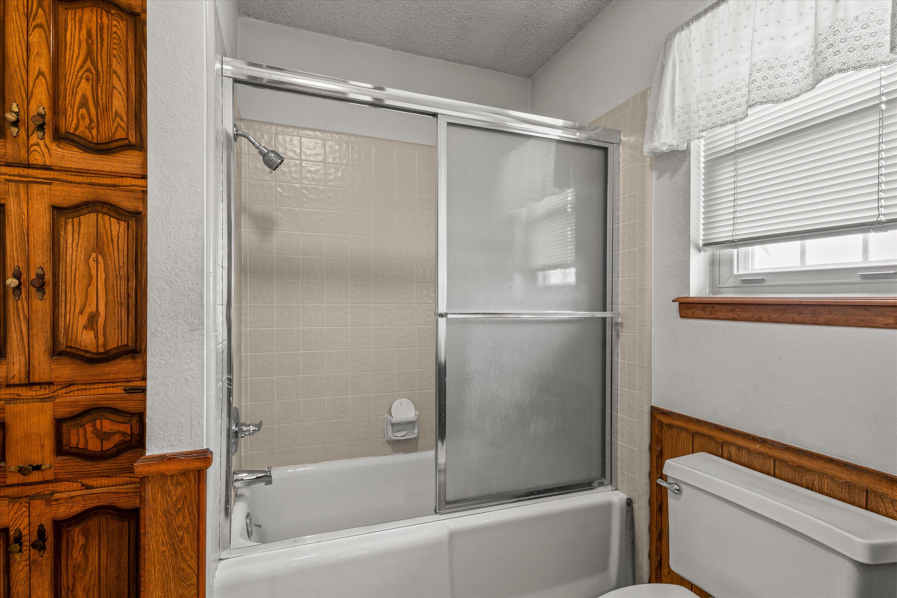 308 West 6th Street Sundown, TX 79372 - Photo 16 of 33 a bathroom with a bathtub and a shower