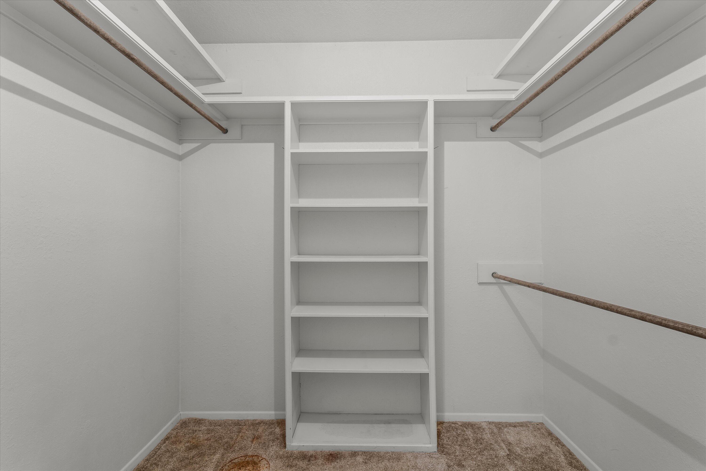 308 West 6th Street Sundown, TX 79372 - Photo 17 of 33 a view of walk in closet with empty racks