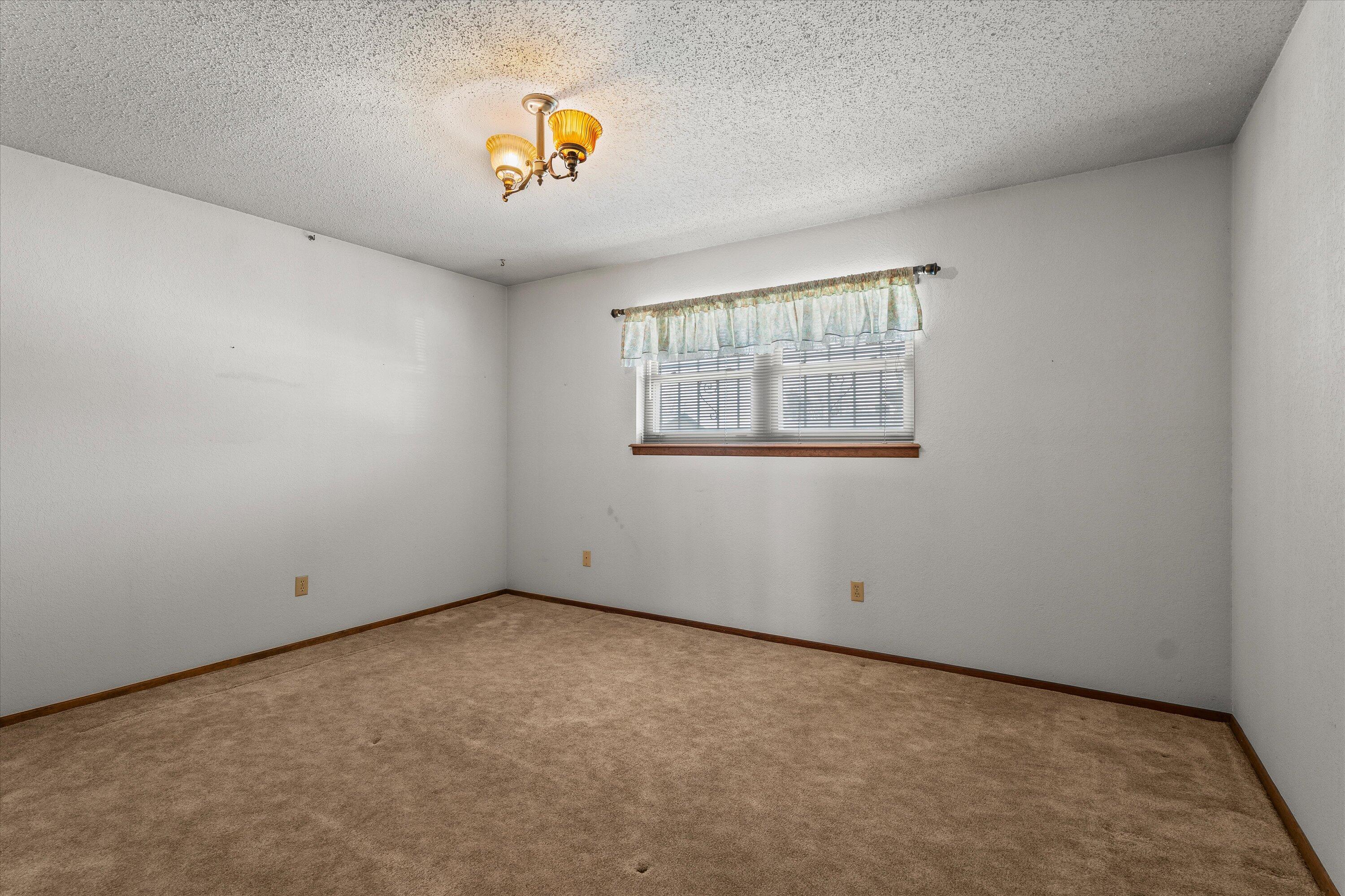 308 West 6th Street Sundown, TX 79372 - Photo 18 of 33 an empty room with windows