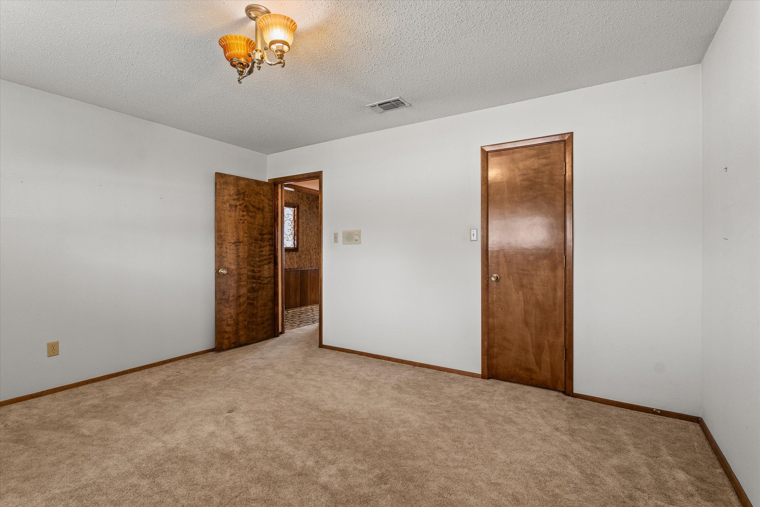 308 West 6th Street Sundown, TX 79372 - Photo 19 of 33 an empty room with a chandelier fan
