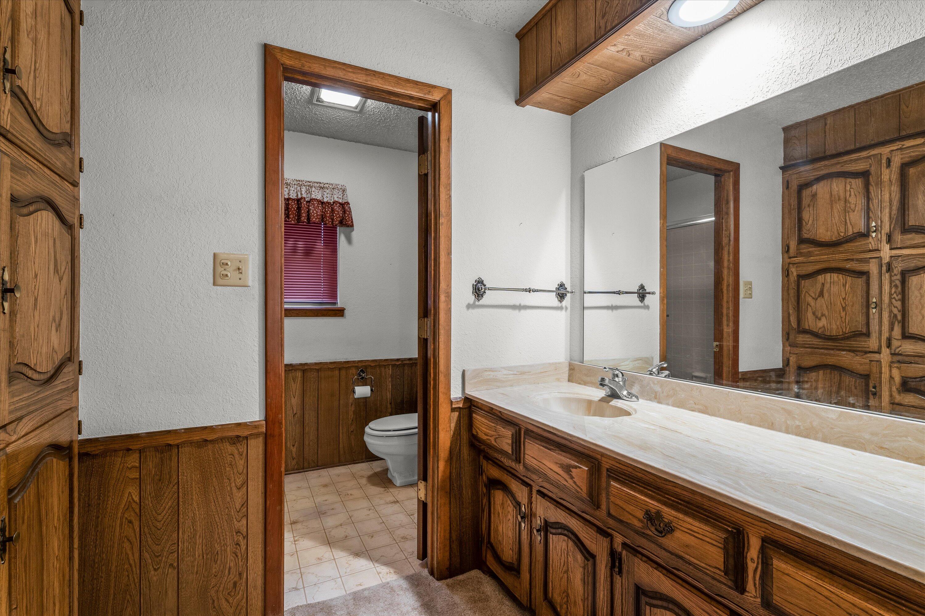 308 West 6th Street Sundown, TX 79372 - Photo 20 of 33 a bathroom with a double vanity sink and a mirror