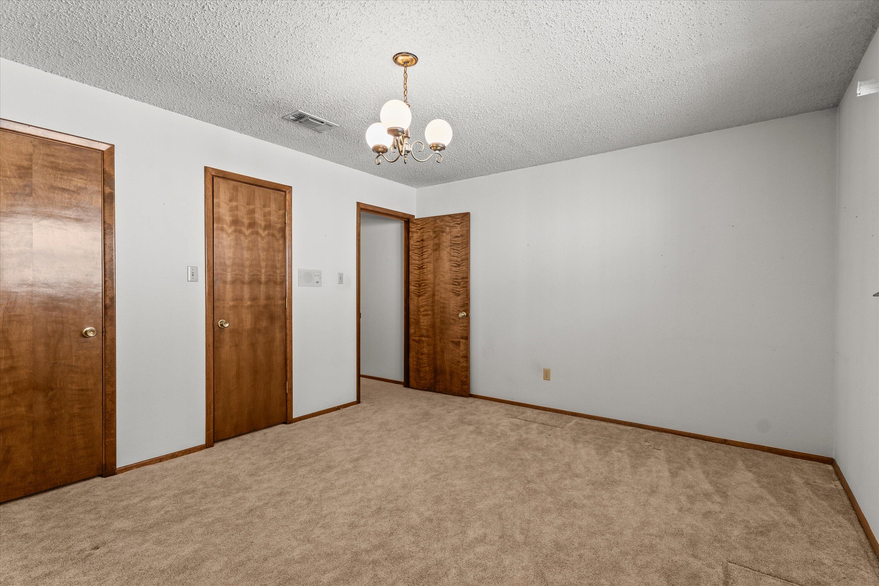 308 West 6th Street Sundown, TX 79372 - Photo 23 of 33 a view of an empty room with a chandelier