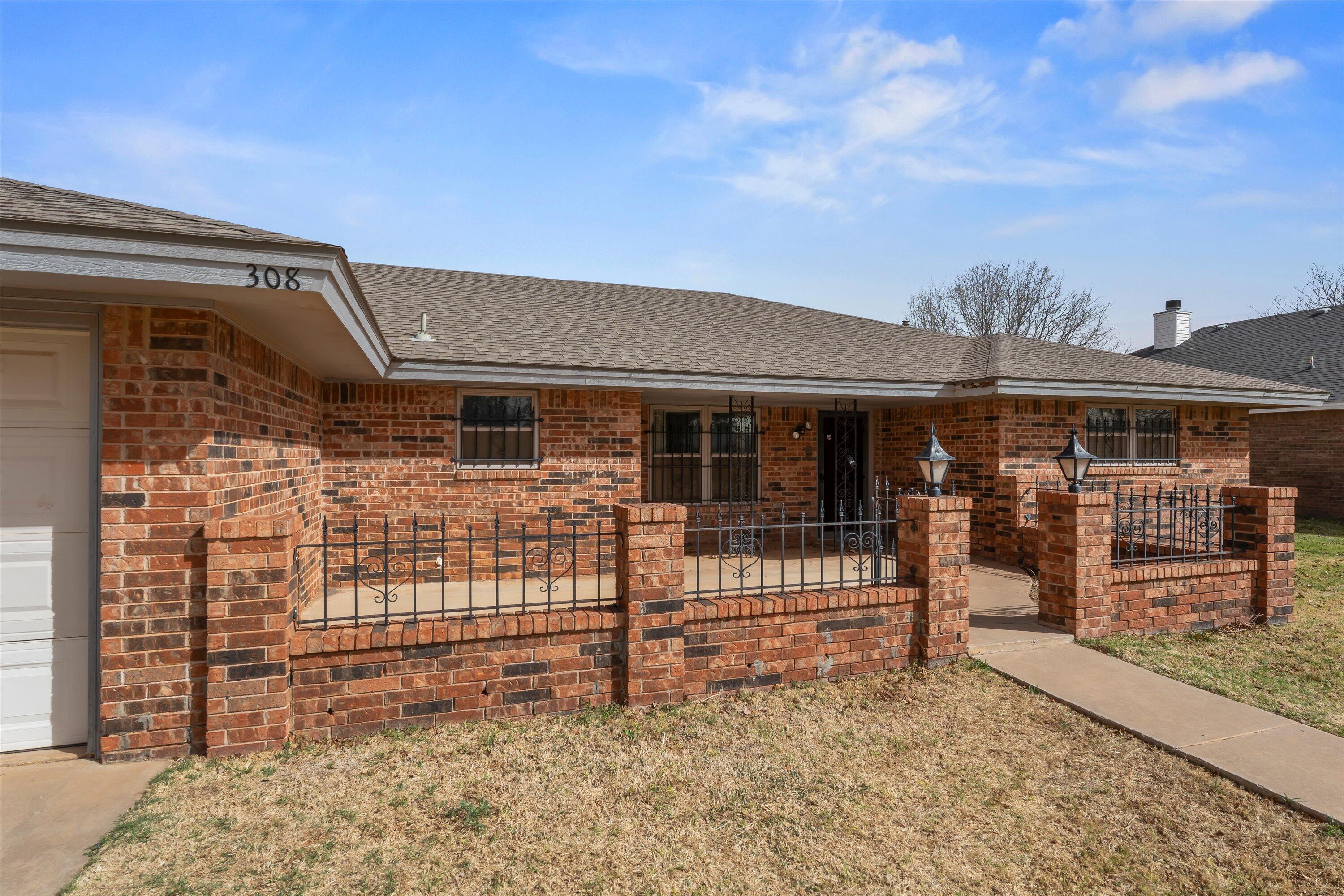308 West 6th Street Sundown, TX 79372 - Photo 3 of 33 front view of a house with a large window