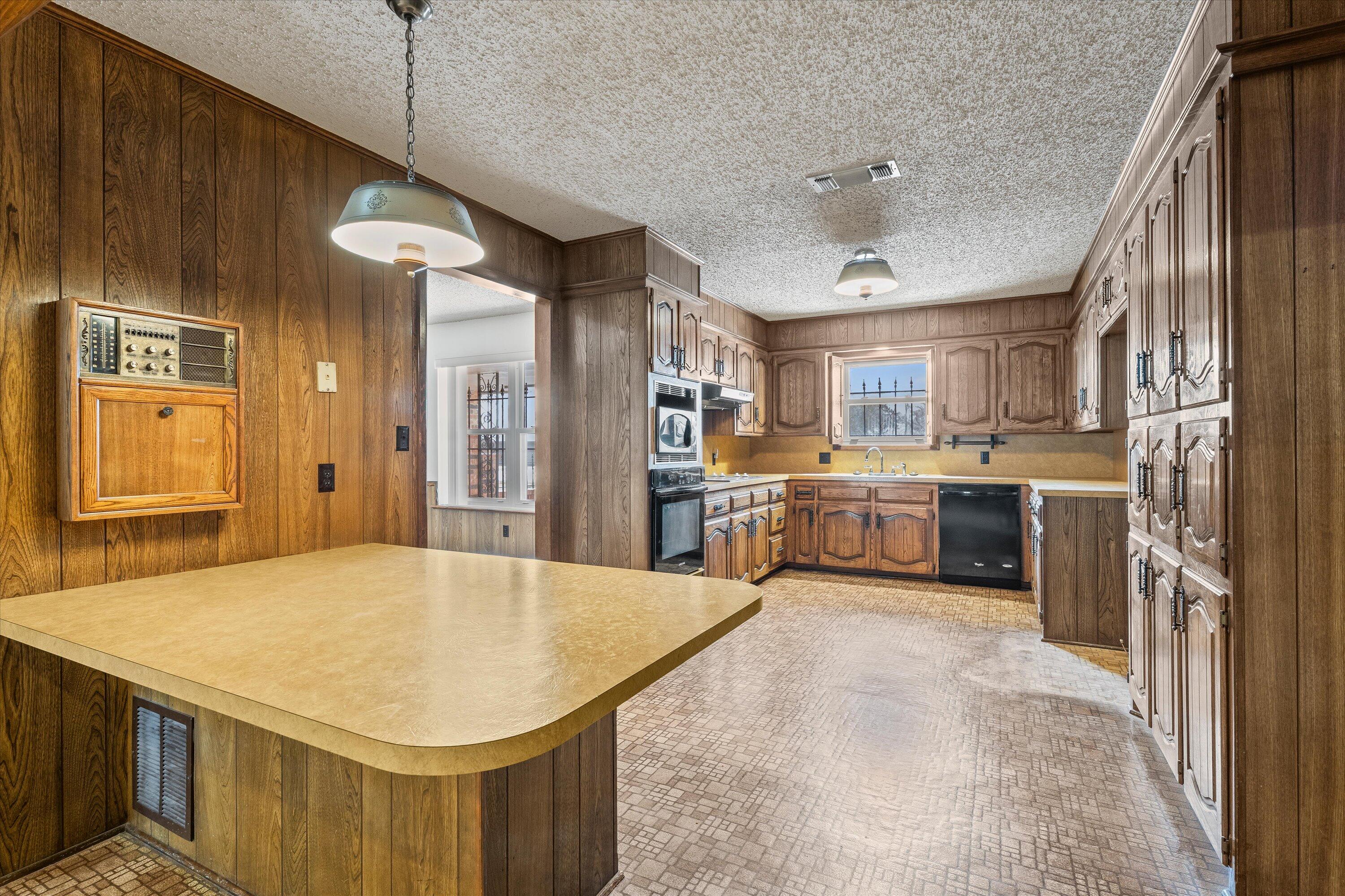 308 West 6th Street Sundown, TX 79372 - Photo 8 of 33 a kitchen with stainless steel appliances granite countertop a sink a stove and a refrigerator